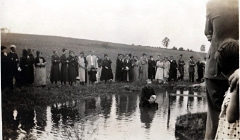  Rev. Henry K. Kreider performing a baptism on his farm south of Campbelltown. Probably in the 1940s. The creek was dammed for the baptism.
